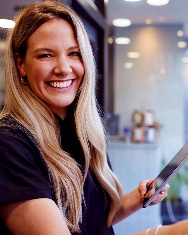 Woman laughing with an Ipad