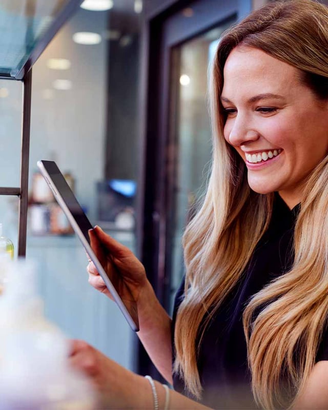 Woman laughing with an Ipad