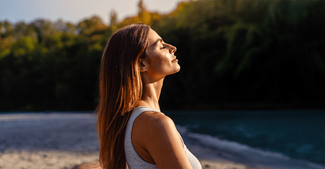woman standing outside in sunlight