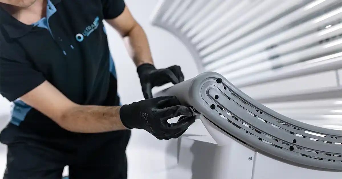 Ultrasun staff cheking profile of a tanning bed