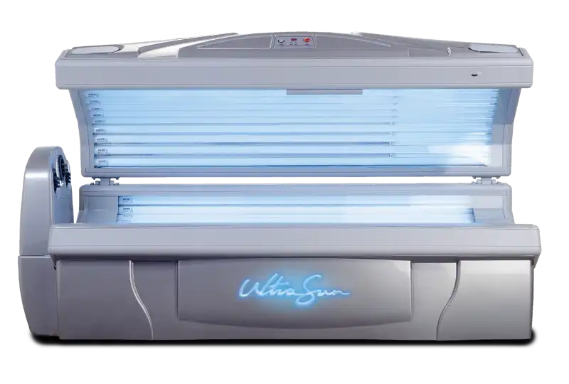 An open, silver lie-down Ultrasun Sunburst tanning bed with illuminated blue UV lamps inside and a glowing blue logo on the front base.