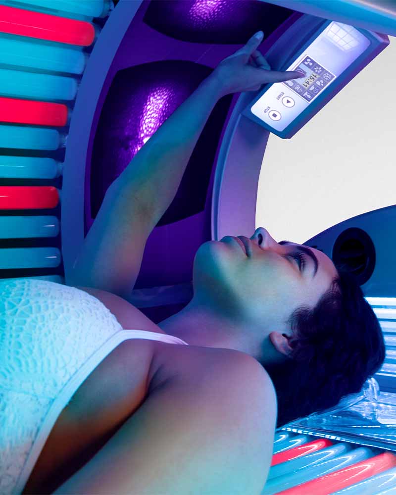 woman inside an Ultrasun Q18 Hybrid tanning bed